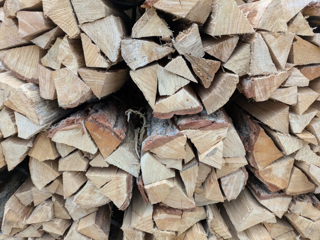 キャンプの焚き火や薪ストーブに使うために積み上げられた広葉樹の薪（ナラ・クヌギなど）